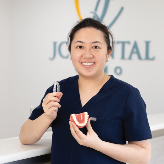 Clear aligner tray held in hand, Clear Aligners Perth at JC Dental Como