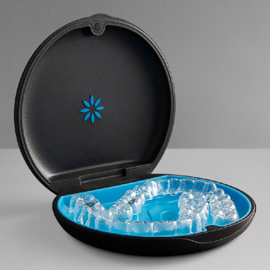 Invisalign clear aligners stored in an open black carrying case - JC Dental Como