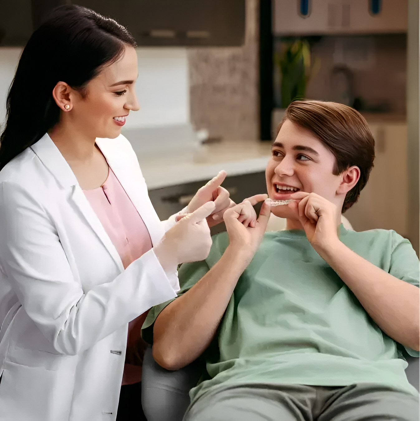 Dentist explaining Invisalign Teen treatment to a teenage patient at JC Dental Como